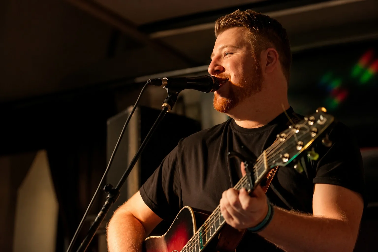 Singer performing with an acoustic guitar